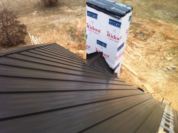 metal roof installation near chimney. 