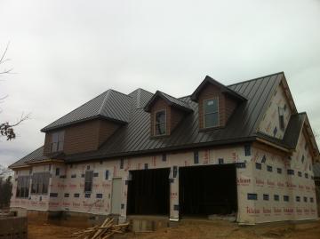 Installing metal roofs on a new home. 